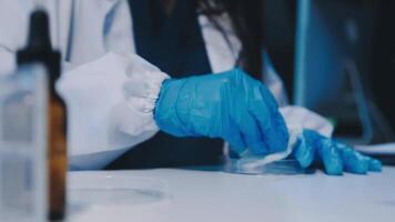 Scientists analyzing coronavirus study data and evaluating microscope. Health care researchers doing some research virus with dropper chemical testing and working in life science laboratory. video
