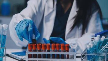 Scientists analyzing coronavirus study data and evaluating microscope. Health care researchers doing some research virus with dropper chemical testing and working in life science laboratory. video