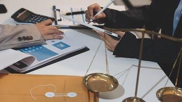 justice and law concept. asian woman lawyer working and judge in a courtroom the gavel, working with tablet and laptop and digital tablet computer on white table video