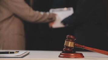 justice and law concept. asian woman lawyer working and judge in a courtroom the gavel, working with tablet and laptop and digital tablet computer on white table video