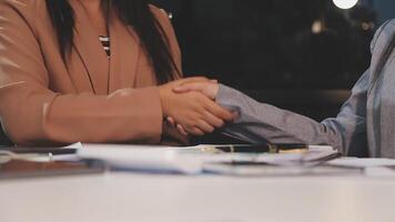 Negotiating business,Image of businesswomen Handshaking,happy with work,the woman she is enjoying with her workmate,Handshake Gesturing People Connection Deal Concept video