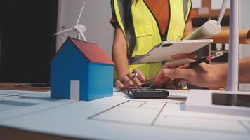 Selective focus, Asian female architect or engineer Drawing the design of the building's interior using a tablet. Asian female architect or engineer Sit and analyze, design projects in the office. video