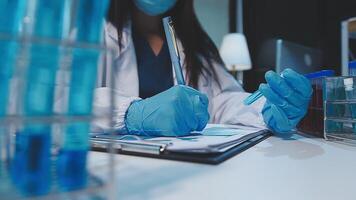 chemist,scientist hand dropping chemical liquid into test tube, science research and development concept video