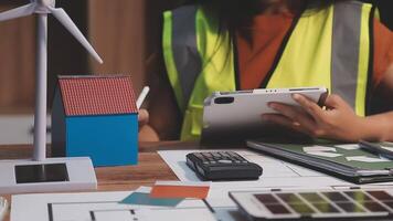 Selective focus, Asian female architect or engineer Drawing the design of the building's interior using a tablet. Asian female architect or engineer Sit and analyze, design projects in the office. video