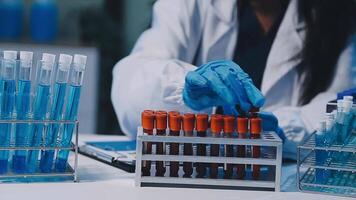 Scientists analyzing coronavirus study data and evaluating microscope. Health care researchers doing some research virus with dropper chemical testing and working in life science laboratory. video