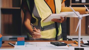 Selective focus, Asian female architect or engineer Currently considering materials for designing modern condominiums. Asian female architect or engineer Sit and analyze, design projects in the office video