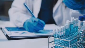 Scientists analyzing coronavirus study data and evaluating microscope. Health care researchers doing some research virus with dropper chemical testing and working in life science laboratory. video