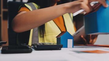 Selective focus, Asian female architect or engineer Currently considering materials for designing modern condominiums. Asian female architect or engineer Sit and analyze, design projects in the office video