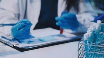Scientists analyzing coronavirus study data and evaluating microscope. Health care researchers doing some research virus with dropper chemical testing and working in life science laboratory. video