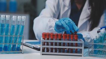 chemist,scientist hand dropping chemical liquid into test tube, science research and development concept video