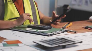 Selective focus, Asian female architect or engineer Drawing the design of the building's interior using a tablet. Asian female architect or engineer Sit and analyze, design projects in the office. video