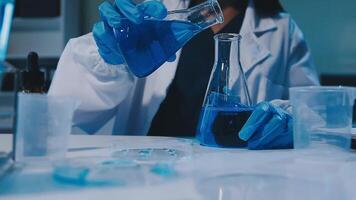 Scientists analyzing coronavirus study data and evaluating microscope. Health care researchers doing some research virus with dropper chemical testing and working in life science laboratory. video