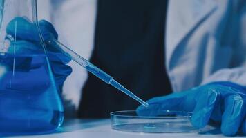 Scientists analyzing coronavirus study data and evaluating microscope. Health care researchers doing some research virus with dropper chemical testing and working in life science laboratory. video