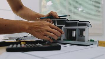 architect man working with laptop and blueprints,engineer inspection in workplace for architectural plan,sketching a construction project ,selective focus,Business concept vintage color video