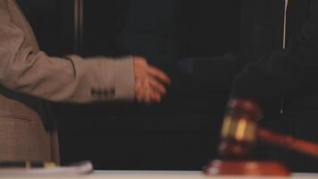 justice and law concept. asian woman lawyer working and judge in a courtroom the gavel, working with tablet and laptop and digital tablet computer on white table video