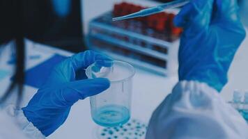 Scientists analyzing coronavirus study data and evaluating microscope. Health care researchers doing some research virus with dropper chemical testing and working in life science laboratory. video