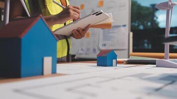Selective focus, Asian female architect or engineer Drawing the design of the building's interior using a tablet. Asian female architect or engineer Sit and analyze, design projects in the office. video