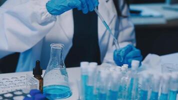 Scientists analyzing coronavirus study data and evaluating microscope. Health care researchers doing some research virus with dropper chemical testing and working in life science laboratory. video