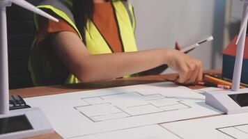 Selective focus, Asian female architect or engineer Drawing the design of the building's interior using a tablet. Asian female architect or engineer Sit and analyze, design projects in the office. video