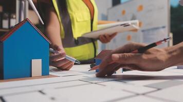 Selective focus, Asian female architect or engineer Drawing the design of the building's interior using a tablet. Asian female architect or engineer Sit and analyze, design projects in the office. video
