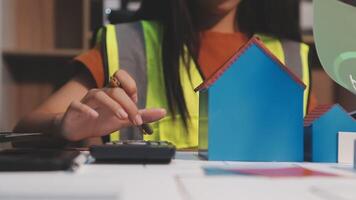 Selective focus, Asian female architect or engineer Drawing the design of the building's interior using a tablet. Asian female architect or engineer Sit and analyze, design projects in the office. video