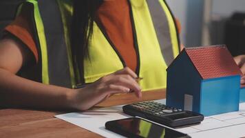 Selective focus, Asian female architect or engineer Drawing the design of the building's interior using a tablet. Asian female architect or engineer Sit and analyze, design projects in the office. video