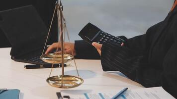 justice and law concept. asian woman lawyer working and judge in a courtroom the gavel, working with tablet and laptop and digital tablet computer on white table video