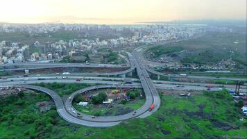 Aerial view of curve highway interchange and cityscape video