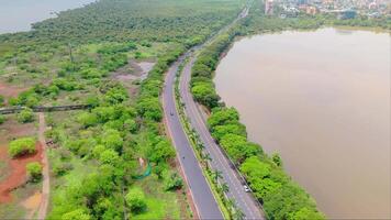 Aerial view of highway between sea and lake video