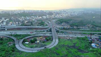 Aerial view of curve highway interchange and cityscape video