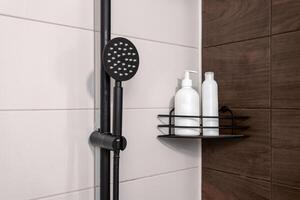Bottles for shampoo and gel in the bathroom against the backdrop of white tiles and shower photo