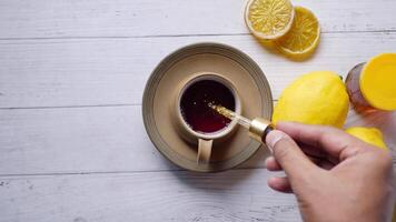 putting eucalyptus essential oils in cup of tea . video