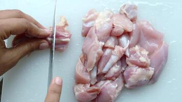 cutting chicken fillet on a chopping board video