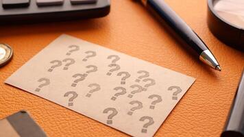 high angle view of question mark on paper on office desk video