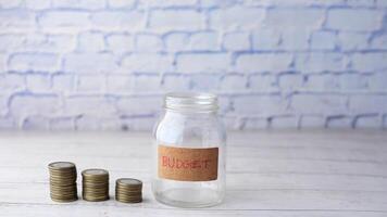budget text on a saving coins jar on white video
