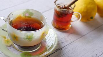 pouring honey in a cup of tea on table video