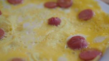 fried egg mixed with sausage on a plate video