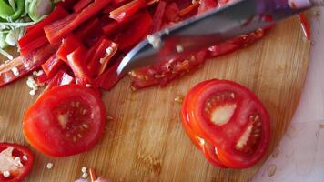cutting fresh tomato on a chopping board at kitchen video