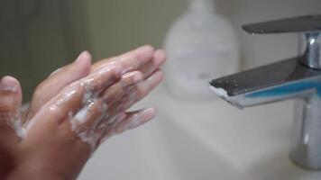 child making a cleansing gesture with soap and water on hands video