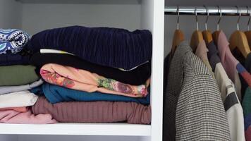 Wellorganized closet with neatly folded clothes and textiles for a tidy, minimalistic look video