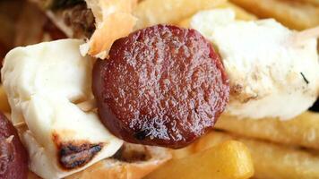 Enjoy a detailed view of a mixed grill skewer with fries, a truly satisfying meal video