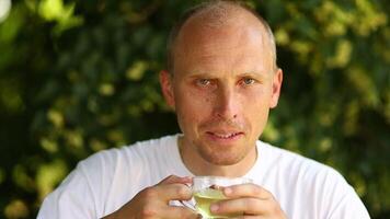 A man drinks tea from a linden tree. video
