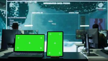 Laptop with green screen display running in military base of operations control tower, space used for gathering intelligence and support secret national defense missions. Command post. Camera B. video