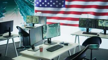 Empty operations center with an American flag working on national safety, armed forces protecting the country with anti terrorism tactics. Military control and command room headquarters. Camera B. video