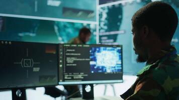 IT programming technician gathering information via neural network and artificial intelligence, employing programming language and new technology to help army operations. Deep learning. Camera B. video