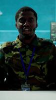 Vertical Army personnel in a high tech command center attends a videocall meeting and communicating crucial information from surveillance systems and cctv. Support national security operations. Camera A. video