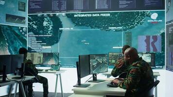 Soldier in a secure environment ensuring data analysis and processing, gathering intelligence for strategic planning to ensure a successful defense mission. Secret service activity. Camera B. video