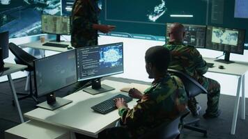 IT software engineer collecting real time data from neural network AI brain, machine learning and data mining algorithms to assist troops with defense missions. Cognitive computing. Camera B. video