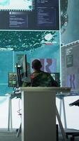 Vertical Officer managing surveillance cctv system with data analysis and processing, gathering real time intelligence for strategic military operations. Successful secret service defense mission. Camera B. video