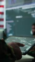 Vertical Military personnel in high tech environment safeguard classified information, monitor cybersecurity threats and digital warfare operations to protect against attacks and data breaches. Camera B. video
